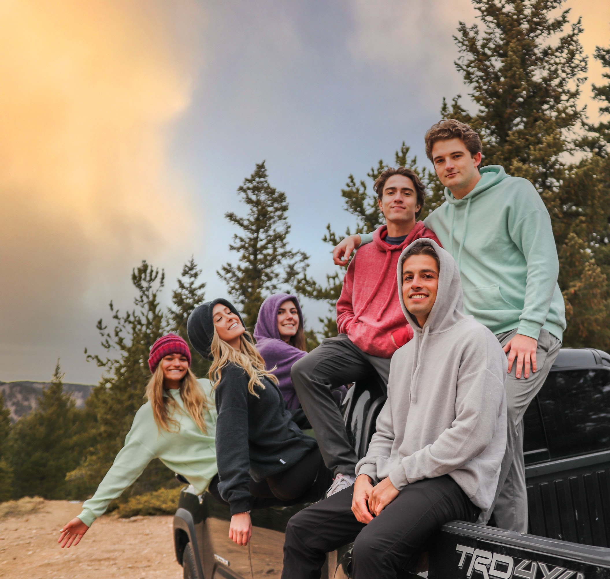 camping friends wearing hoodies